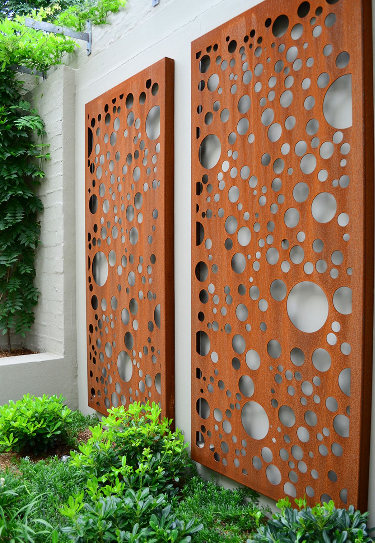 Paravane din Corten cu rol decorativ pentru a colora o grădină între ziduri. Foto via Out House Design